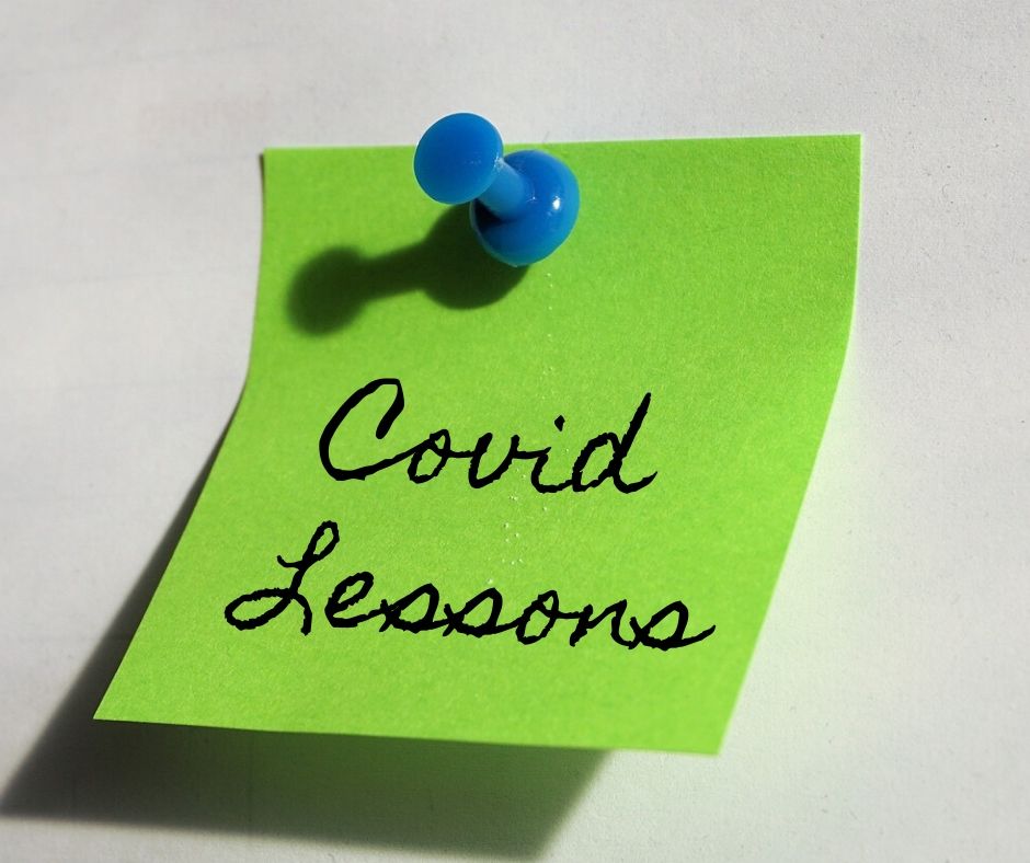 Green Post-It Note with the words: Covid Lessons written in cursive.